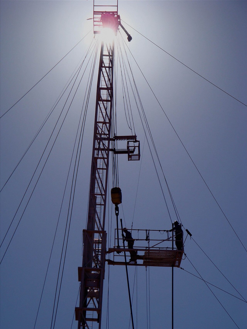 Derrickmen working high on a drilling mast